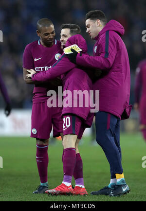 Manchester City's Fernandinho (left), Bernardo Silva (centre) and Ederson celebrate after the Emirates FA Cup, Fourth Round match at Cardiff City Stadium. Stock Photo