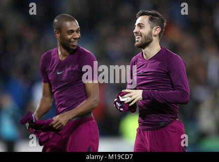 Manchester City's Fernandinho (left) and Bernardo Silva celebrate after the Emirates FA Cup, Fourth Round match at Cardiff City Stadium. Stock Photo