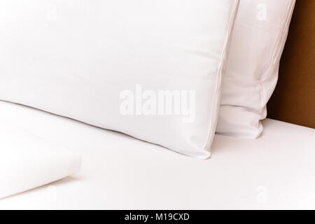 Decorated Bed - White bedsheet cusion in Hotel Room Stock Photo