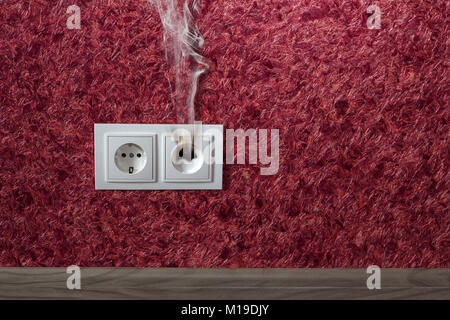 white household socket has burned from short circuit Stock Photo