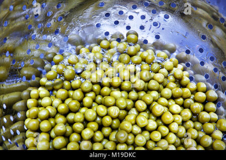 tinned green peas in the course of washing for preparation of dish Stock Photo