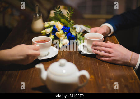white cups in the hands with a shallow depth of field Stock Photo