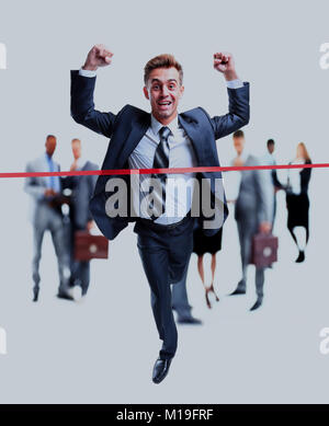Happy businessman running through finishing line. Stock Photo