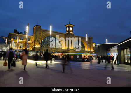 Early evening on a January night at Kings Cross railway station, London with commuters heading for their trains Stock Photo