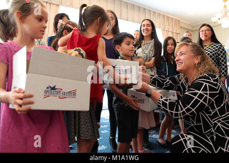 Los Alamitos Mayor Shelley Hasselbrink presents an Operation Gratitude Battalion Buddy gift box to the child of a deployed Soldier Nov. 16, 2017, during a Thanksgiving Appreciation Lunch at Joint Forces Training Base Los Alamitos, California. The 14th annual event brought together elected officials, community leaders, Soldiers, Airmen and family members of deployed troops for a holiday meal on the base. (Air National Guard photo by Senior Airman Crystal Housman) Stock Photo