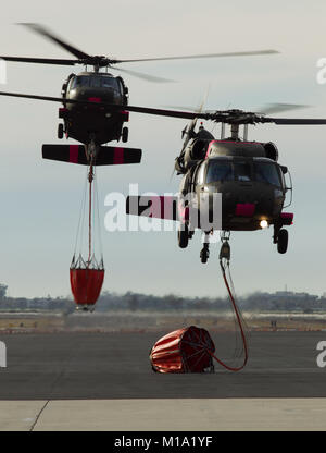 A pair of California National Guard UH-60 Black Hawk helicopters from B Company, 1st Battalion, 140th Aviation Regiment, return to Camarillo Airport in Camarillo, California, Sun., Dec. 10, 2017, after making water drops on the Thomas Fire burning in Ventura County. (U.S. Air National Guard photo by Senior Airman Crystal Housman) Stock Photo