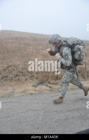 110914-Z-DH635-015 Spc. Daniel Bietz of Lincoln, Calif., a combat engineer with 235th SAPPER Company, 579th Engineer Battalion, 49th Military Police Brigade, does his best Rocky impression during his 5.2 miles ruck march as part of the Best Warrior Competition at Camp San Luis Obispo, Calif., Sept. 14, 2011.  Bietz is an English major at the University of California – Davis. (Army National Guard photo/ Sgt. Salli Curchin) Stock Photo