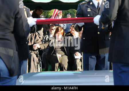 WASHINGTON, Aug. 14, 2014 -- Susan Myers presents a flower on the coffin of  her husband U.S. Army Maj. Gen. Harold Greene during a burial service at  section 60 of Arlington National