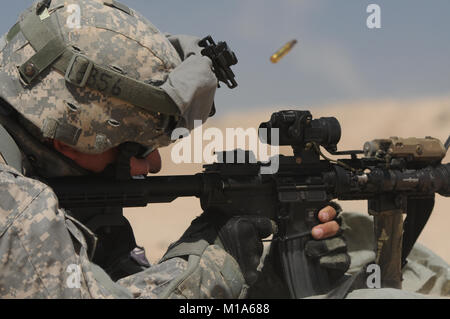 120509-Z-PP889-006 Spc. Matthew Schoch with the California Army National Guard’s Bravo Company, 1st Battalion, 184th Infantry (Light), fires away at a paper target to zero his M4 carbine rifle May 9 during a National Training Center rotation at Fort Irwin, Calif. (Army National Guard photo/Spc. Grant Larson) Stock Photo