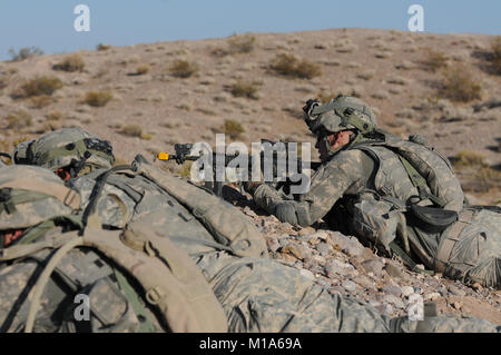 120512-Z-PP889-009 Pfc. Max Knudsen with the California Army National Guard’s Bravo Company, 1st Battalion, 184th Infantry (Light), overlaps his squad's sectors of fire during a field training exercise May 12 at the National Training Center in Fort Irwin, Calif. (Army National Guard photo/Spc. Grant Larson) Stock Photo