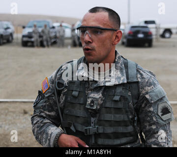 130911-Z-IB797- Sgt. 1st Class Francisco Serrato, Headquarters and Headquarters Company, 1106th Theatre Aviation Sustainment Maintenance Group, takes a much needed breather after the 5.9 mile ruck march event, Sept. 11, 2013, at the Best Warrior Competition, which was held at Camp San Luis Obispo, Calif., by the 223rd Regional Training Institute (U.S. Army National Guard photo by Spc. James Wilton/Released) Stock Photo