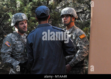 Human intelligence collectors try to get information from a role player acting as the Afghan National Police during an intelligence-gathering mission at Panther Strike 2014 in Camp Williams, Utah, June 17. During the exercise, more than 100 military intelligence Soldiers donned local attire and occupied simulated Afghan villages. Panther Strike is an annual training event that brings together military intelligence Soldiers from across the U.S. and partner nations for a large-scale, dynamic, full-spectrum intelligence exercise. (U.S. Army Photo National Guard photo/Spc. Brianne M. Roudebush/Rel Stock Photo