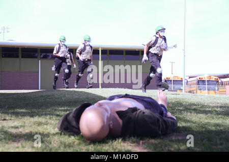 More than 200 members of the California Cadet Corps from 16 schools traveled to the California Military Institute (CMI) in Perris, California, on Saturday for this year's State Academic, Athletic, Marksmanship, Community Emergency Response Team (CERT) Competition. Currently in more than 50 elementary, middle and high schools across the state and comprising 5,000 cadets, the Cadet Corps develops youths with leadership skills and discipline who perform well academically and serve their communities. Here the CERT team from CMI sprints to help an injured patient. Photo by Brandon Honig Stock Photo