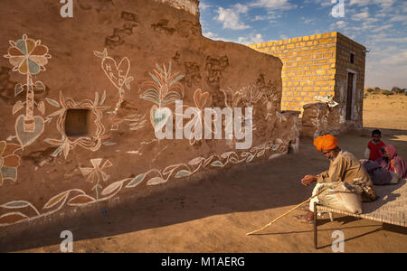 Old Rajasthani man sitting on a cot at a rural village near Thar desert Jaisalmer, Rajasthan. Stock Photo