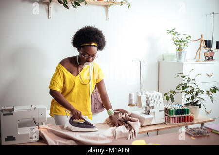 african Woman seamstress Ironing cloth Stock Photo