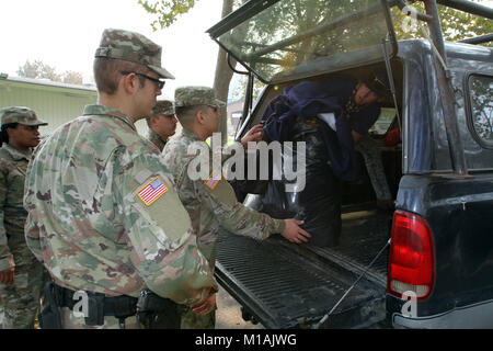 California Army National Guardsmen from the 49th Military Police Brigade assist a civilian unload blankets and towels at the Sonoma County Fairgrounds at the height of the 2017 Northern California wildfires that ravaged Napa, Solano and Sonoma counties in October. (Army National Guard photo by Staff Sgt Eddie Siguenza) Stock Photo