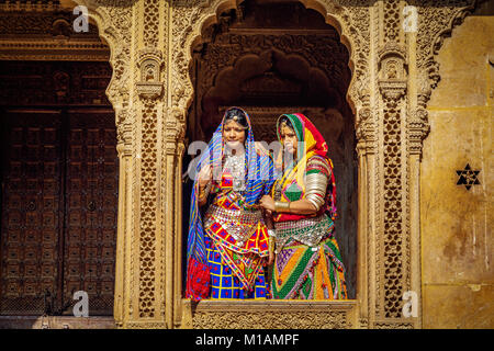 Indian women in Rajasthani outfit with jewelery pose at Patwon Ki Haveliyan Jaisalmer, Rajasthan. Stock Photo