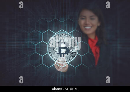 Businesswoman touching virtual bitcoin icon. Cryptography concept Stock Photo