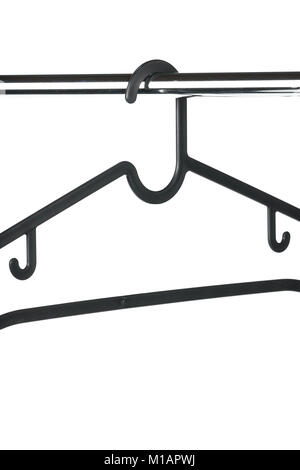 Coat hanger / clothes hanger on a clothes rail with a white background. Potential copy space above and below hanger. Stock Photo