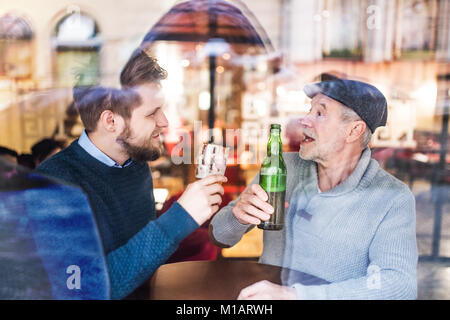Senior father and his young son in a pub. Stock Photo