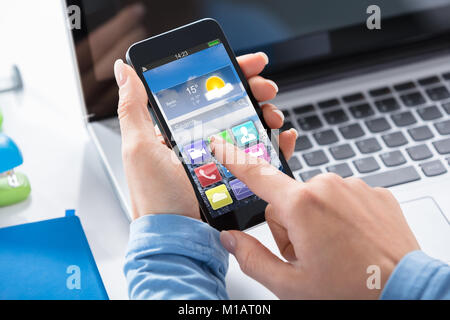 Close-up Of A Woman Using Touchscreen Smart Phone With Applications On Screen Stock Photo