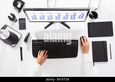 Close-up Of A Businesswoman Looking At Calendar Using Computer On Desk Stock Photo