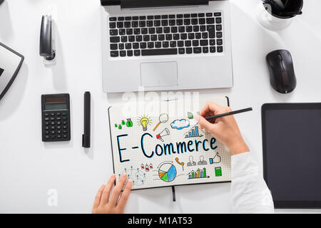 Elevated View Of A Businesswoman Drawing E-commerce Chart On Notebook At Workplace Stock Photo
