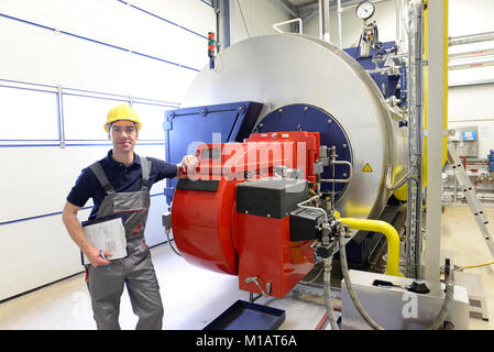 workers in an industrial plant check the systems with modern technology Stock Photo