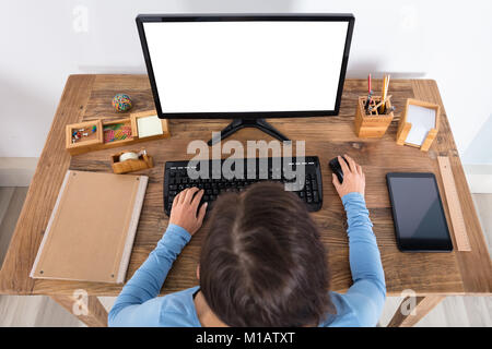Elevated View Of A Woman Using Computer At Home Stock Photo