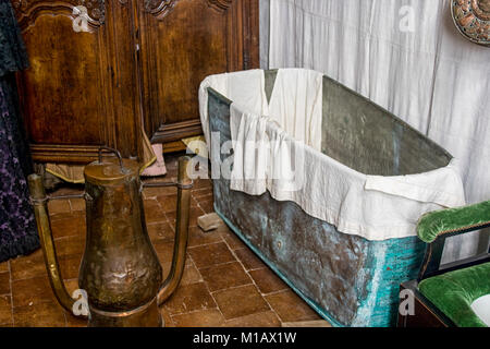 Bathroom from the 17th century in France with a metal bathtub and a copper water heater Stock Photo