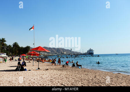 Jordanians and tourist having a good time on Al-Ghandour Beach in Aqaba, Jordan. Stock Photo