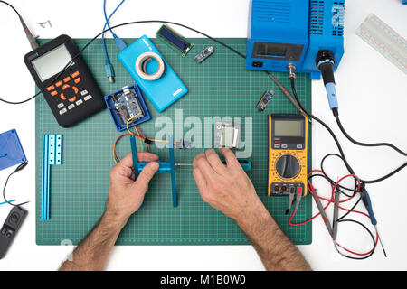 manual assembly of electronic mechanical device from a set of spare part set constructor Stock Photo