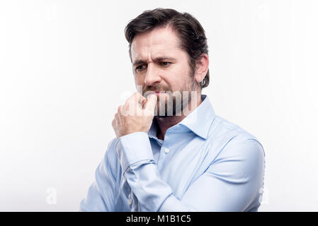 Pleasant middle-aged man being deep in thoughts Stock Photo