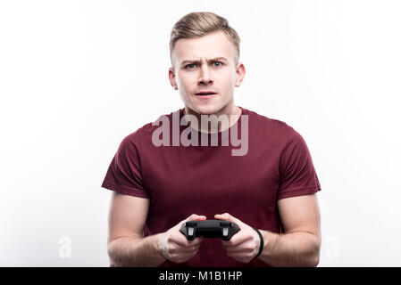 Handsome fair-haired man playing video games Stock Photo