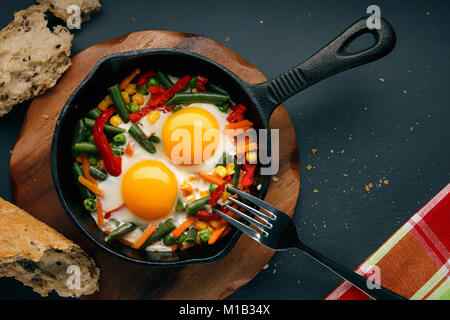 Fried eggs in a cast iron Stock Photo