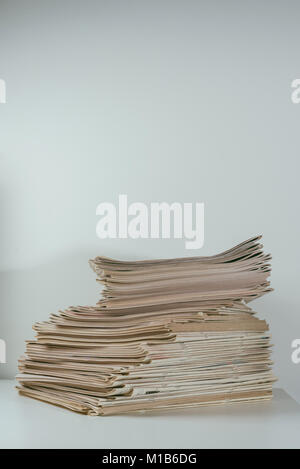 Stack of newspapers placed on white background Stock Photo