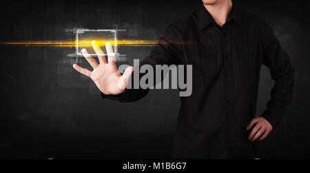 Tech person touching button with orange light beams concept Stock Photo