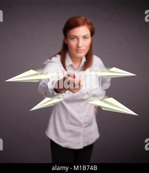 Beautiful young lady throwing origami airplanes Stock Photo