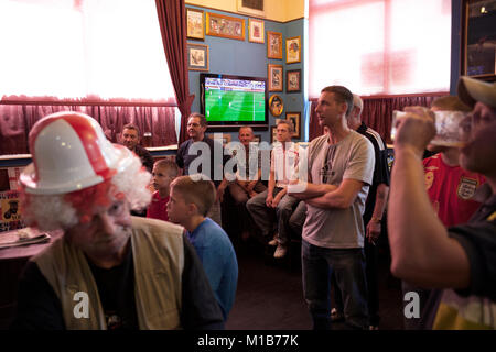 Locals at the Queens Head pub, Burlslem, Stoke-on Trent, watch the England World Cup match versus Slovenia, 23rd June 2010. Burslem was once the Mother town of the ceramic and pottery industry, but now only a few of the Pot Banks are fuctioning as most of the industry has moved to the far east. Rich Bowen Photography Stock Photo