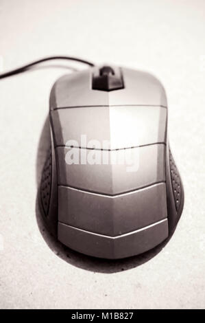 Modern black typical cabled optical computer mouse with two buttons and a scroll wheel on a white background Stock Photo