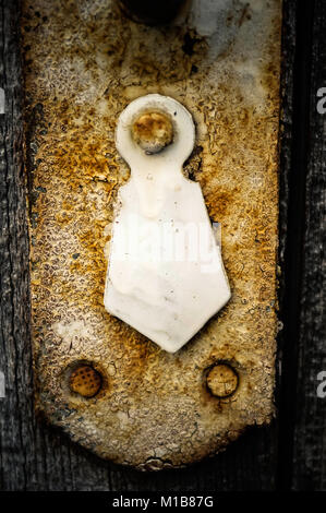 Rusty keyhole in old wooden wardrobe, closeup. selective focus Stock Photo