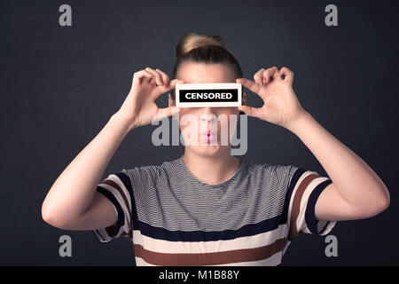 Pretty girl with censored paper sign holding in hand Stock Photo