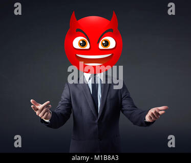 Funny businessman wears devil smiley face Stock Photo