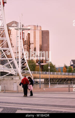 A couple looking at a map on Salford Quays, Manchester, England, UK. Stock Photo