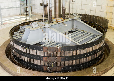 Hautvillers, France - August 11, 2017: Pressing the grapes with an old press in the Pressoir in Champagne village Hautvillers near Reims and Epernay. Stock Photo