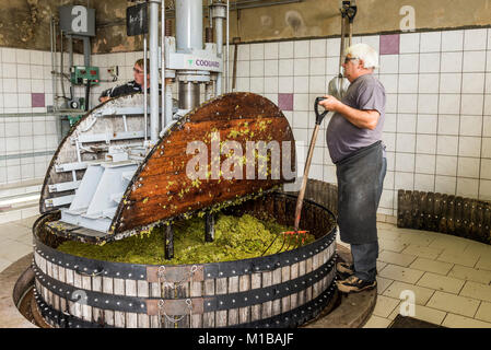 Hautvillers, France - August 11, 2017. Pressing the grapes with an old press with two working men in the Pressoir in Champagne village Hautvillers nea Stock Photo