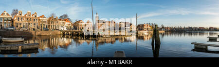 Blokzijl, The Netherlands - November 24, 2016: Panorama of the harbor with two flat bottoms (ships) of Blokzijl in the province of Overijssel. With ol Stock Photo