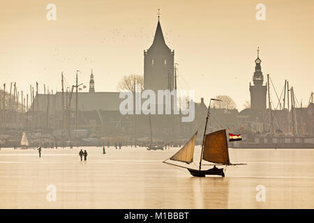 The Netherlands, Monnickendam, skyline of village. ice sailing boat on frozen lake called Gouwzee. Winter. Stock Photo