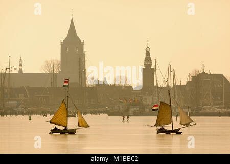 The Netherlands, Monnickendam, skyline of village. ice sailing boat on frozen lake called Gouwzee. Winter. Stock Photo