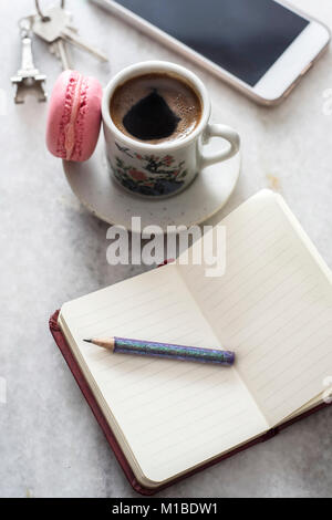 Diary,smartphone, and cup of coffee on a marble table, close up Stock Photo